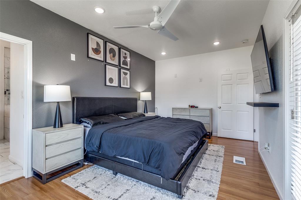 3121 Rutz Street Dallas, TX 75212 - Photo 15 of 24 a bedroom with a large bed and a flat screen tv