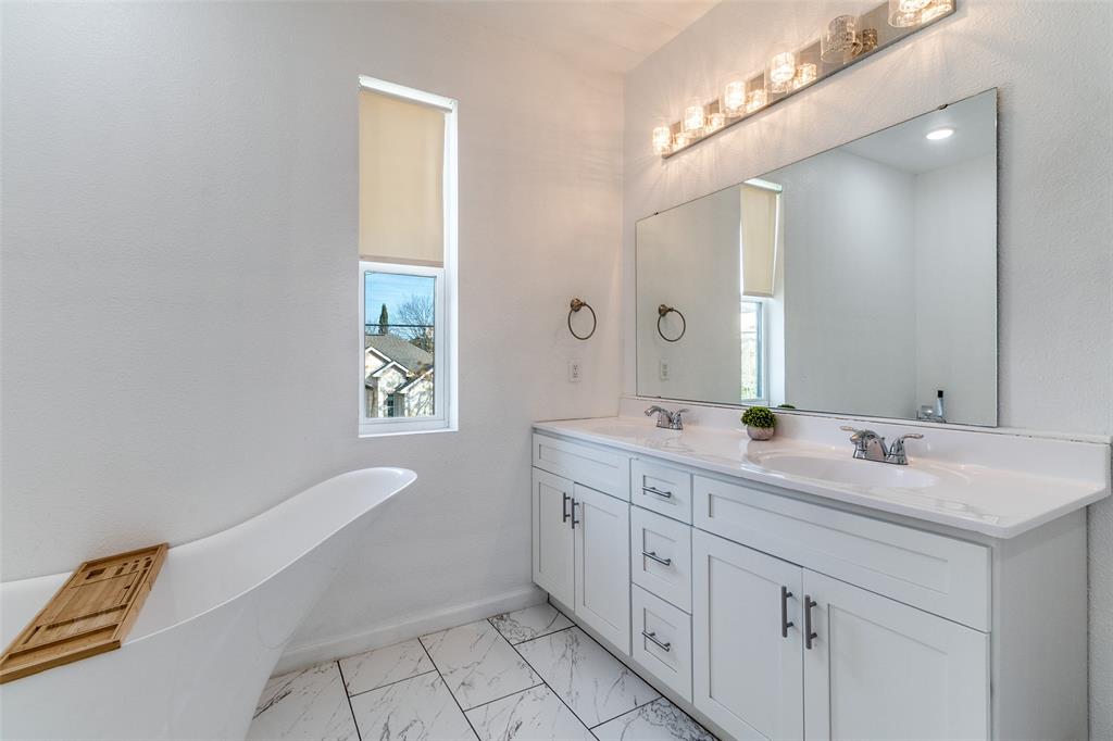3121 Rutz Street Dallas, TX 75212 - Photo 17 of 24 a bathroom with a double vanity sink a mirror and a bathtub