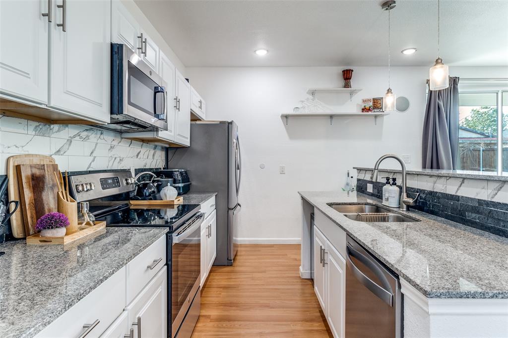 3121 Rutz Street Dallas, TX 75212 - Photo 9 of 24 a kitchen with stainless steel appliances granite countertop a sink stove and refrigerator