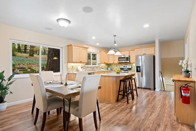 a dining room with furniture and wooden floor