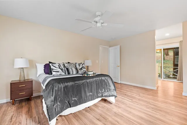 a bedroom with a bed and wooden floor