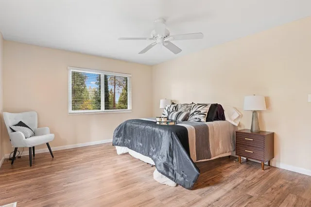 a spacious bedroom with a bed and a lamp