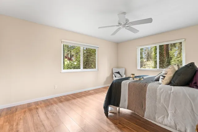 a bed sitting in a bedroom next to a window