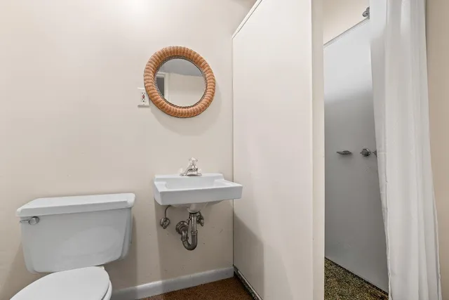 a bathroom with a toilet and a sink