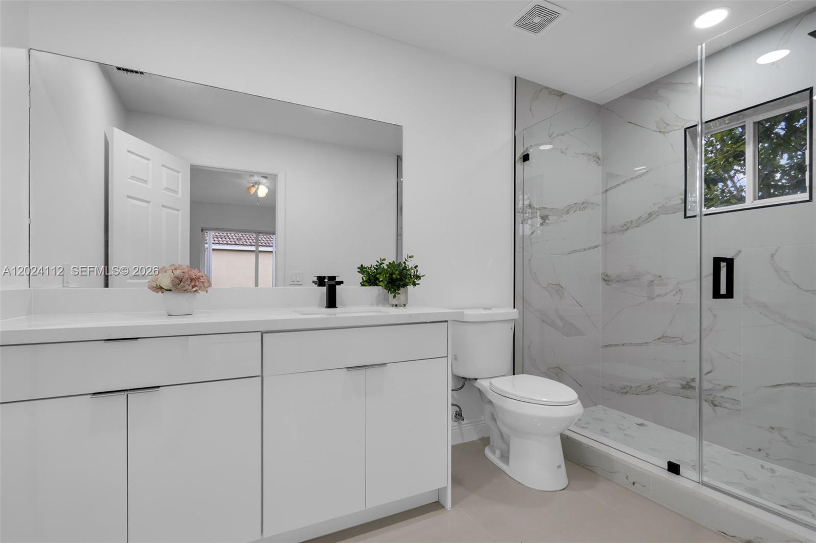 4366 Mahogany Ridge Drive Weston, FL 33331 - Photo 15 of 41 a bathroom with a sink a toilet and shower