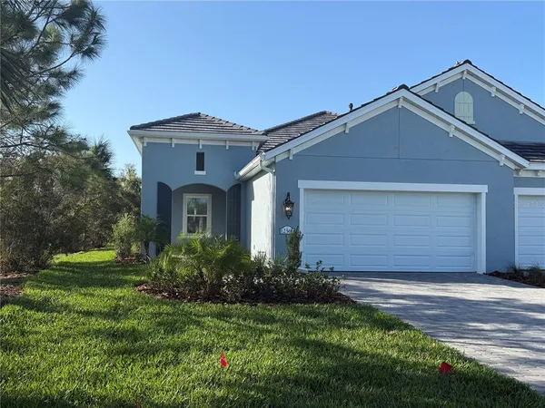 a front view of a house with a yard and garage