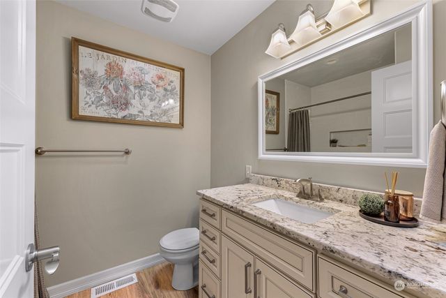 a view of a livingroom with furniture wooden floor and a window