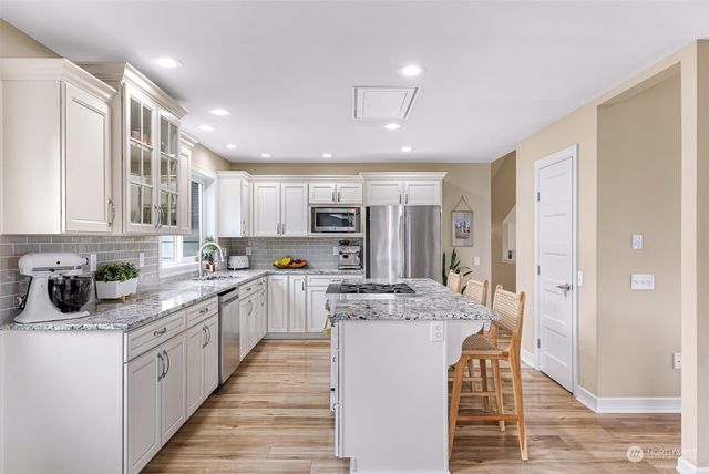 a large kitchen with stainless steel appliances lots of counter top space and cabinets