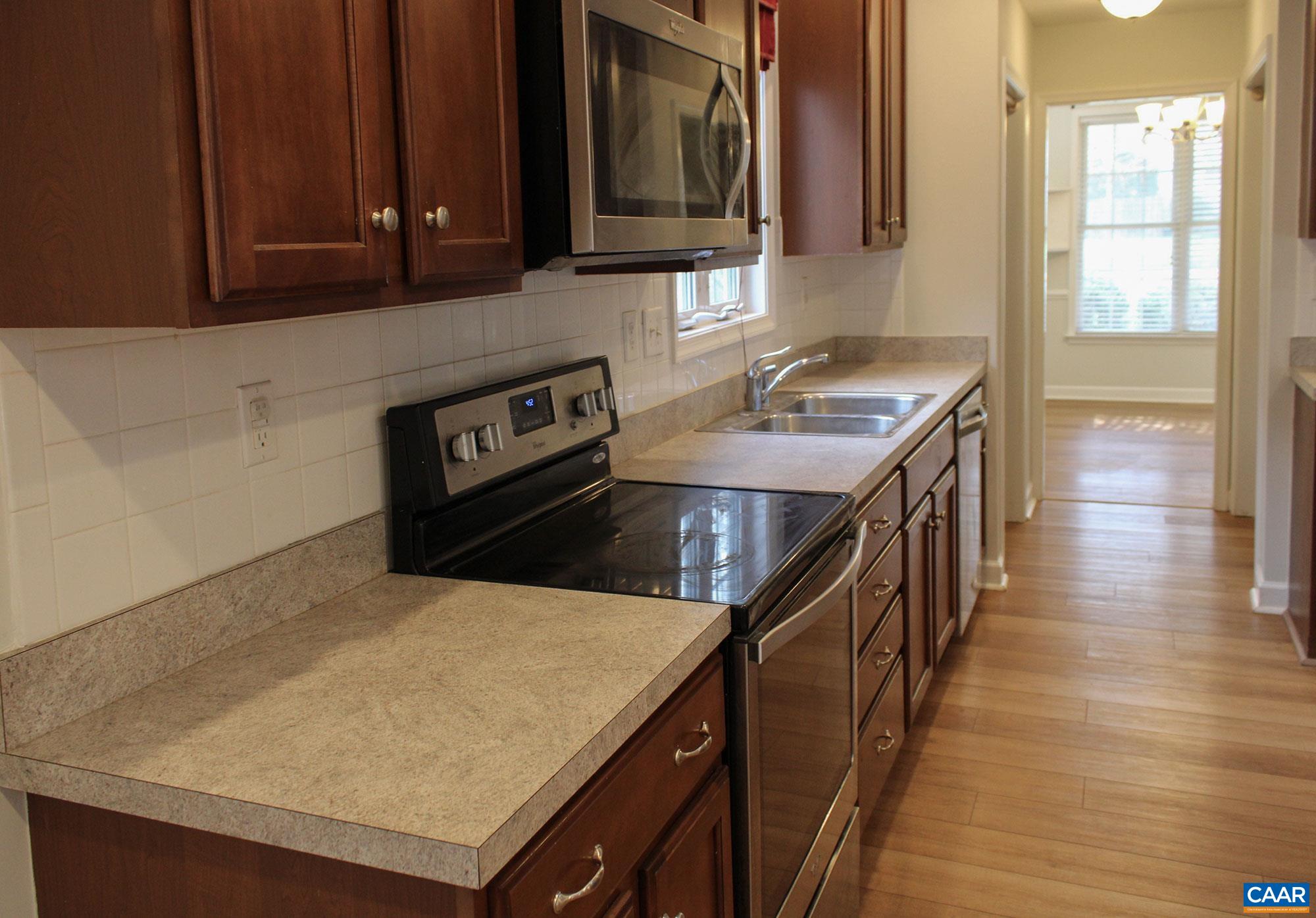 5335 Brookwood Road Crozet, VA 22932 - Photo 12 of 29 a kitchen with a stove a sink and a microwave