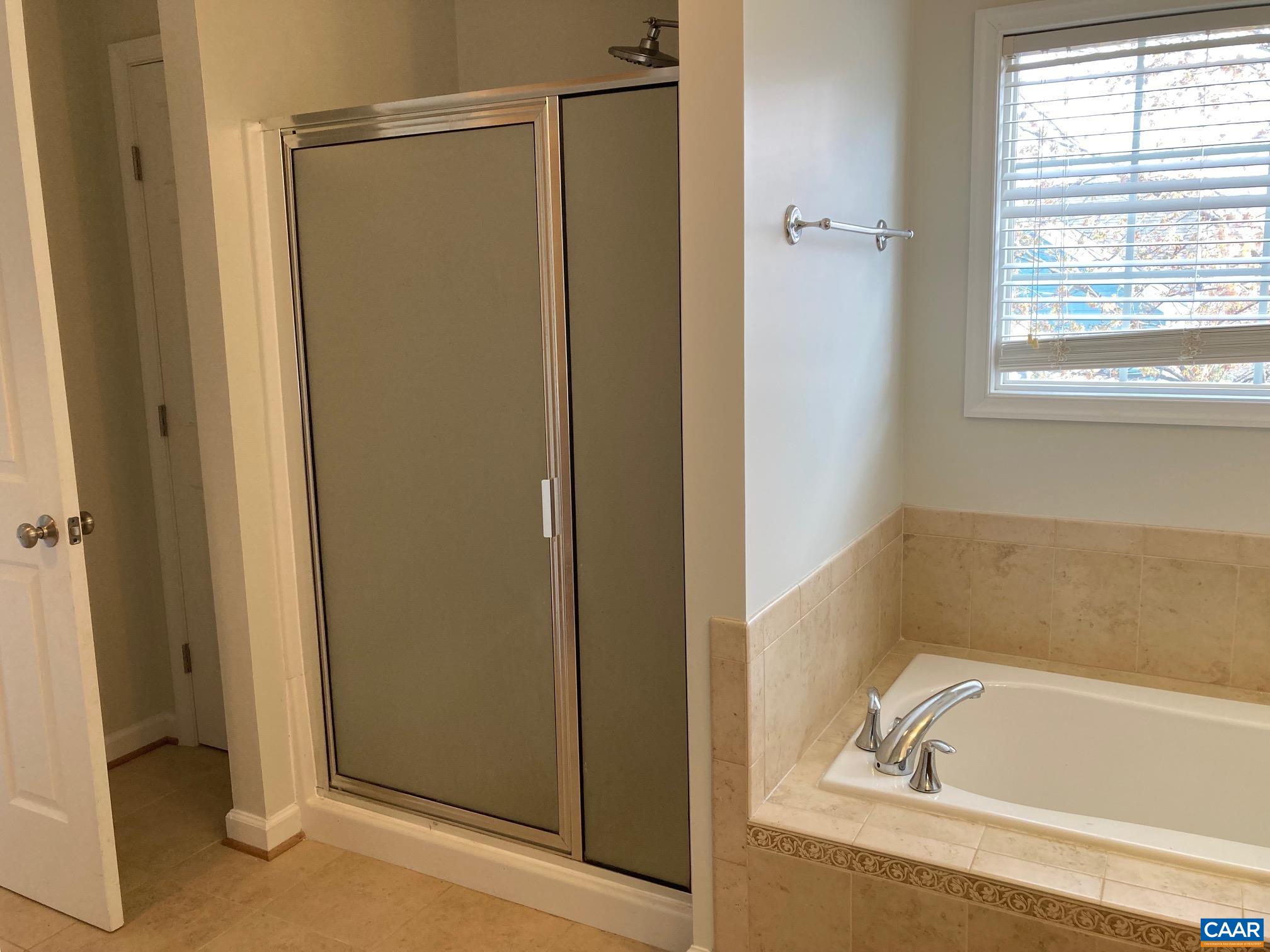 5335 Brookwood Road Crozet, VA 22932 - Photo 22 of 29 a bathroom with a tub and a shower