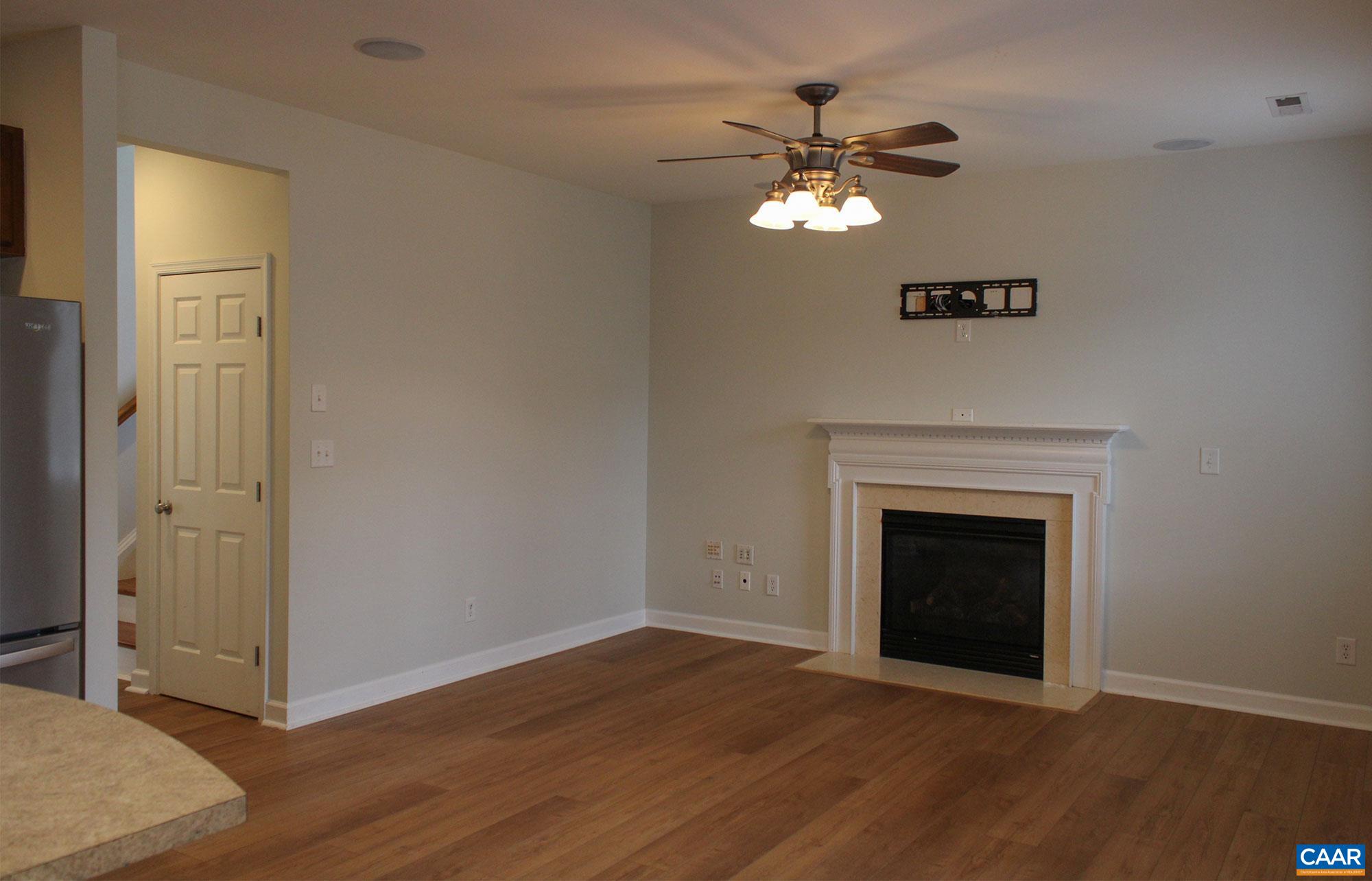 5335 Brookwood Road Crozet, VA 22932 - Photo 9 of 29 a view of an empty room with wooden floor and a fireplace