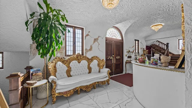 a living room with furniture and a potted plant