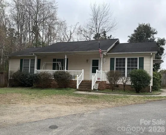 a front view of a house with garden yard and porch