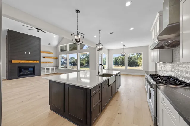 a kitchen with counter top space appliances and windows