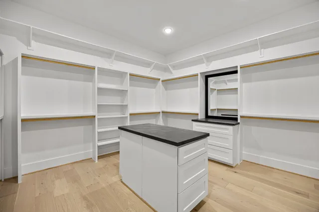 a bathroom with a granite countertop shower a mirror and a sink