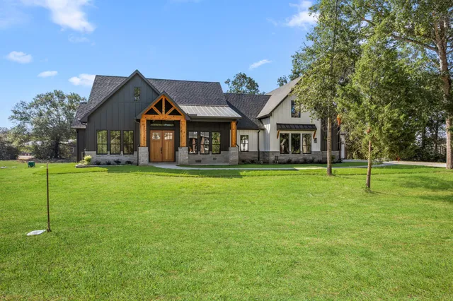 a front view of house with yard and green space
