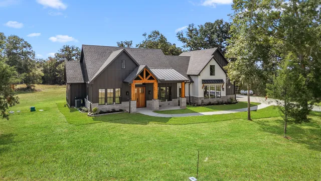 an aerial view of a house with swimming pool and big yard