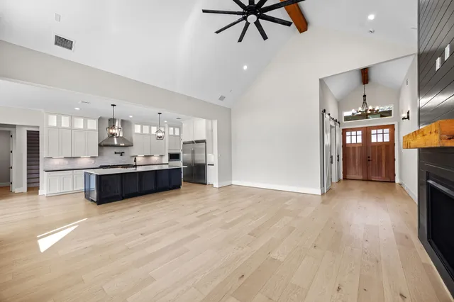 a large kitchen with stainless steel appliances kitchen island a large counter space a sink and appliances