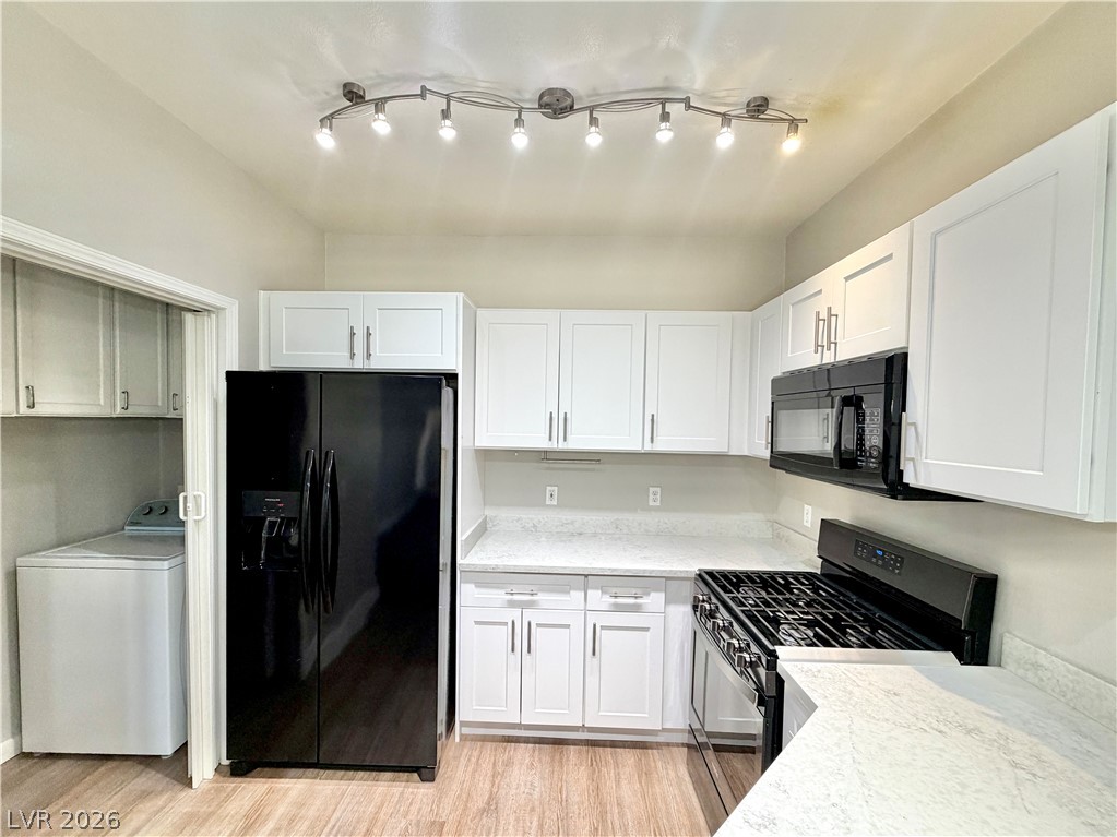 8555 West Russell Road, Unit 2018 Las Vegas, NV 89113 - Photo 2 of 23 A well-equipped kitchen with track lighting features ample cabinetry and modern appliances.