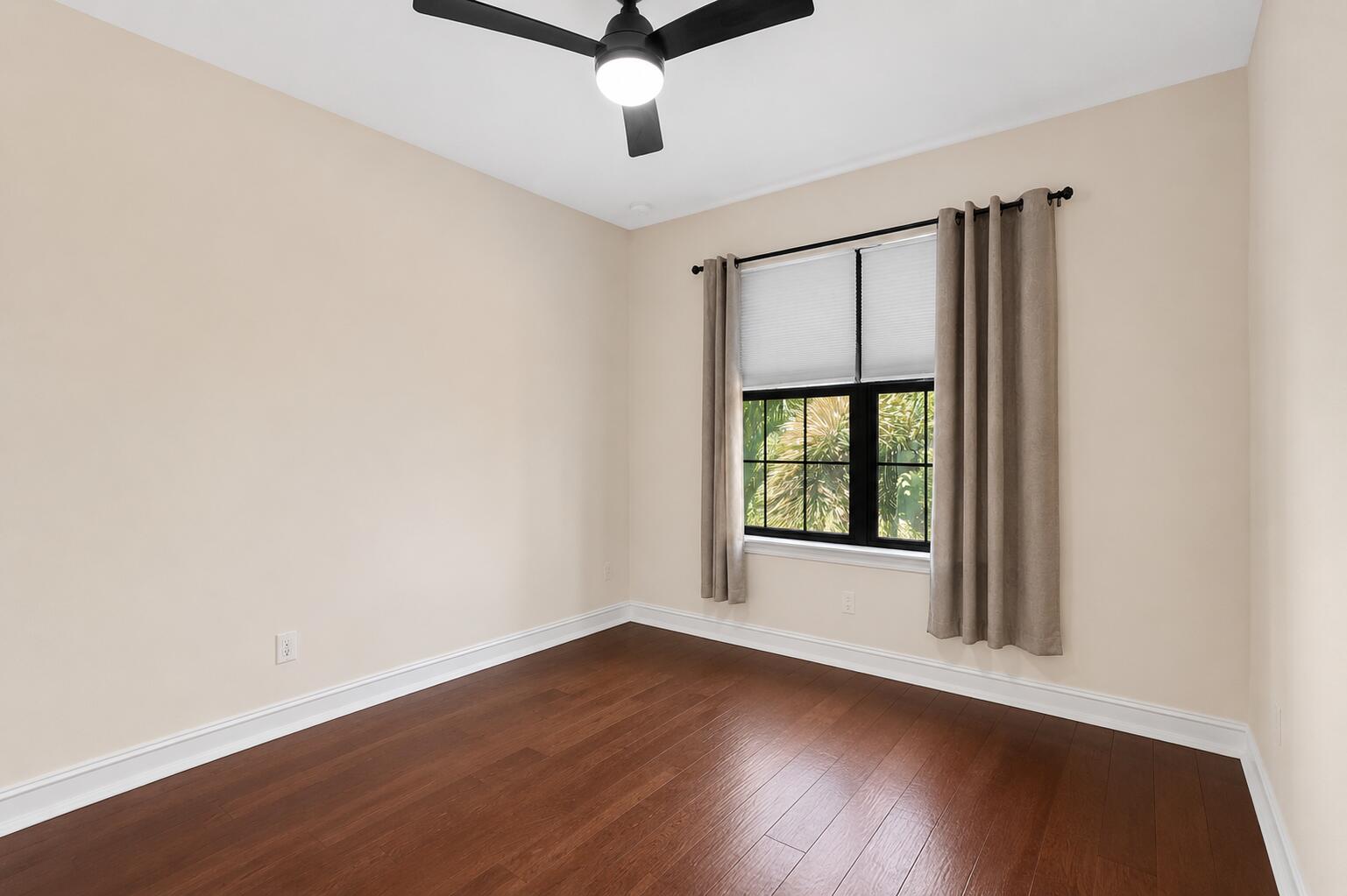 16610 Gateway Bridge Drive Delray Beach, FL 33446 - Photo 25 of 67 an empty room with wooden floor and windows