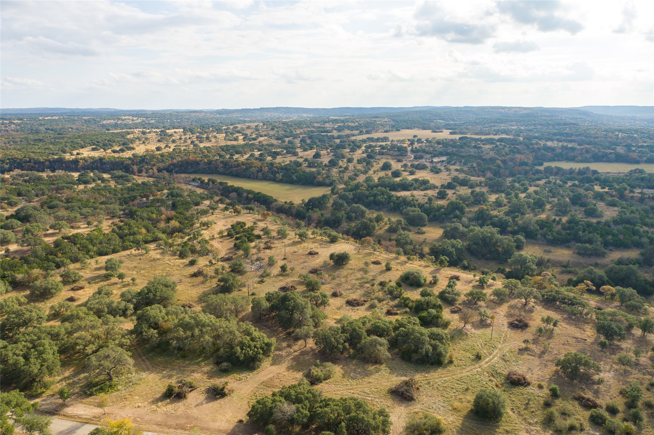 7301 Creek Road Dripping Springs, TX 78620 - Photo 16 of 22 an aerial view of residential houses with outdoor space