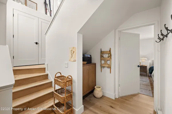 a bedroom with two beds and a large mirror