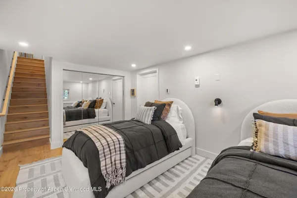 a bedroom with a bed and a painting on the wall