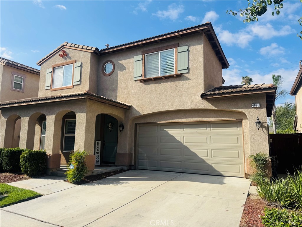 4065 Garvey Way Riverside, CA 92501 - Photo 1 of 43 a front view of a house with garden