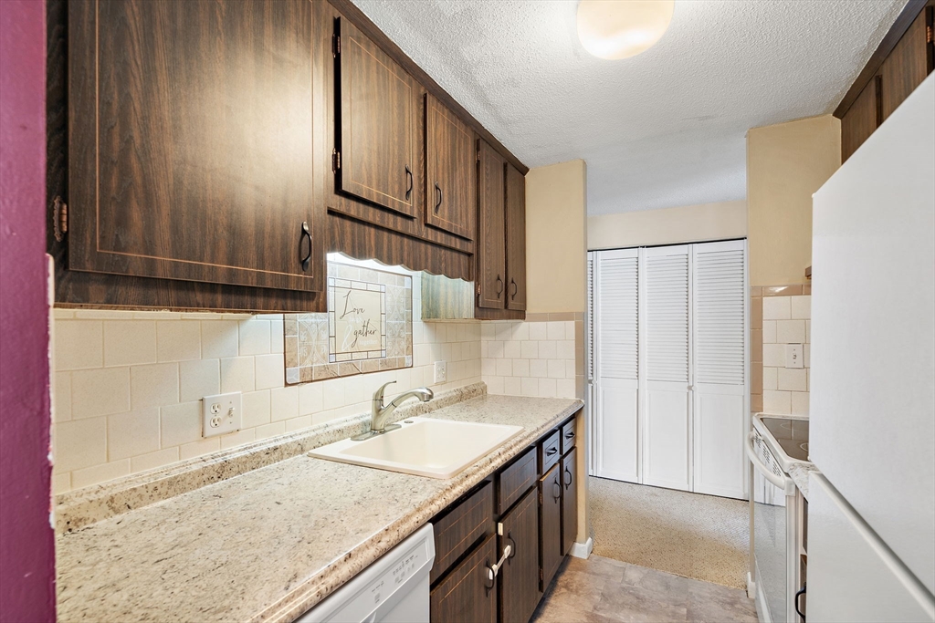 35 High Street, Unit 9 Marlborough, MA 01752 - Photo 15 of 25 a bathroom with a granite countertop sink and a mirror