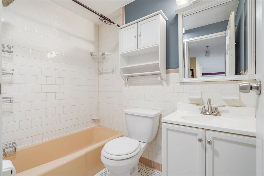 35 High Street, Unit 9 Marlborough, MA 01752 - Photo 16 of 25 a bathroom with a sink toilet and shower