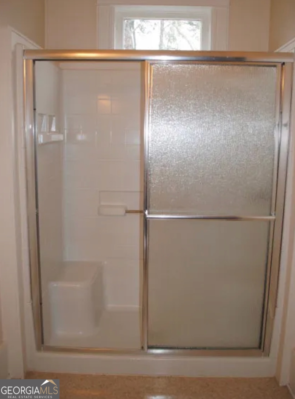 516 West Altamaha Street Fitzgerald, GA 31750 - Photo 16 of 17 a bathroom with a glass shower door