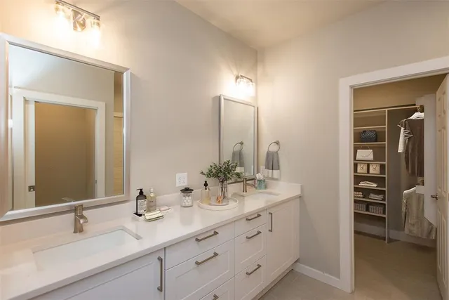a bathroom with a double vanity sink and a mirror