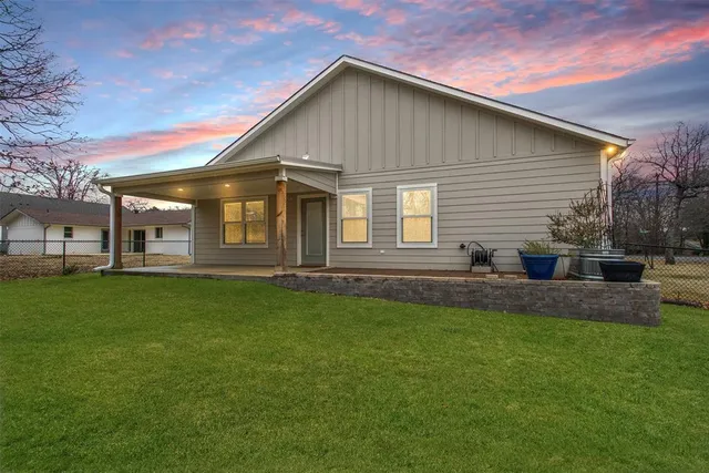 a front view of house with yard and green space