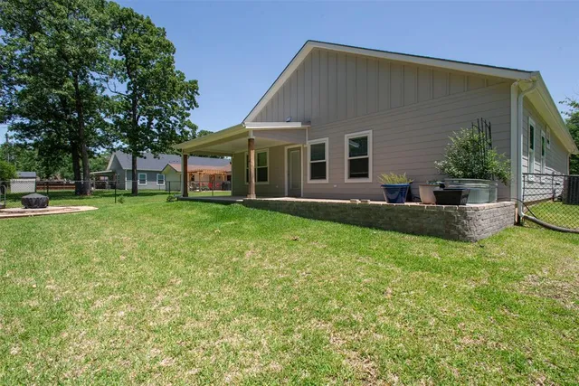 a front view of house with a garden