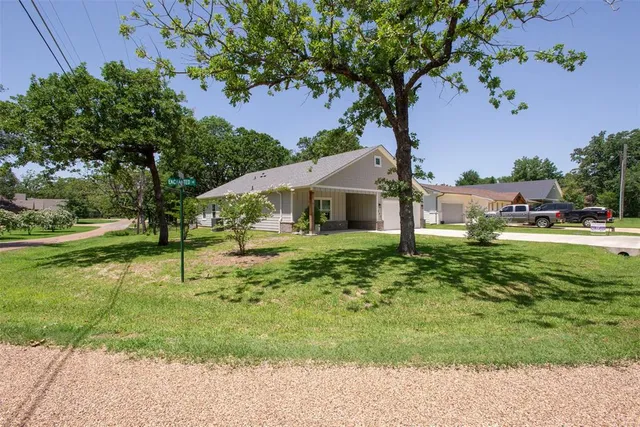 a house with green field in front of it