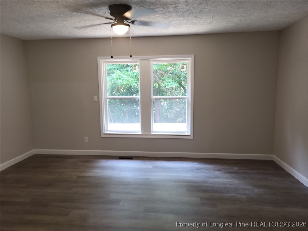 182 Summerhill Road Fayetteville, NC 28303 - Photo 16 of 24 a view of an empty room with wooden floor and a window
