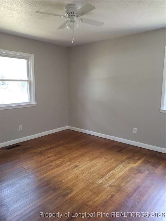 182 Summerhill Road Fayetteville, NC 28303 - Photo 18 of 24 an empty room with wooden floor and windows