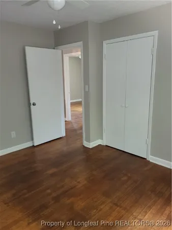 an empty room with wooden floor and closet