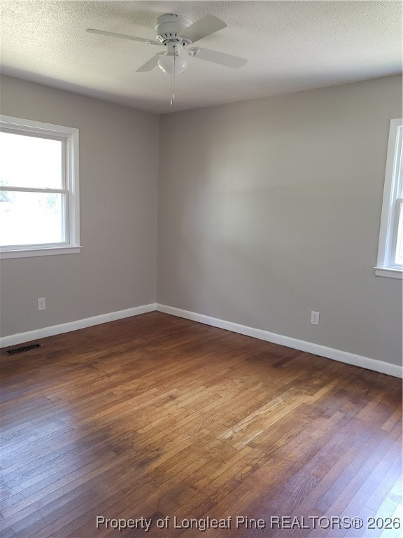 182 Summerhill Road Fayetteville, NC 28303 - Photo 24 of 24 an empty room with wooden floor and windows