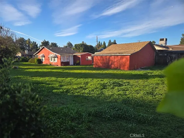 a front view of house with yard and trees
