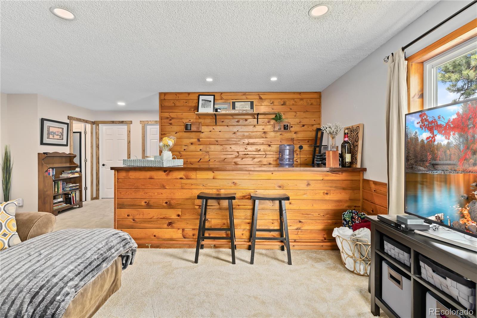 278 Overlook Drive Bailey, CO 80421 - Photo 17 of 37 a room with a bed and a flat screen tv