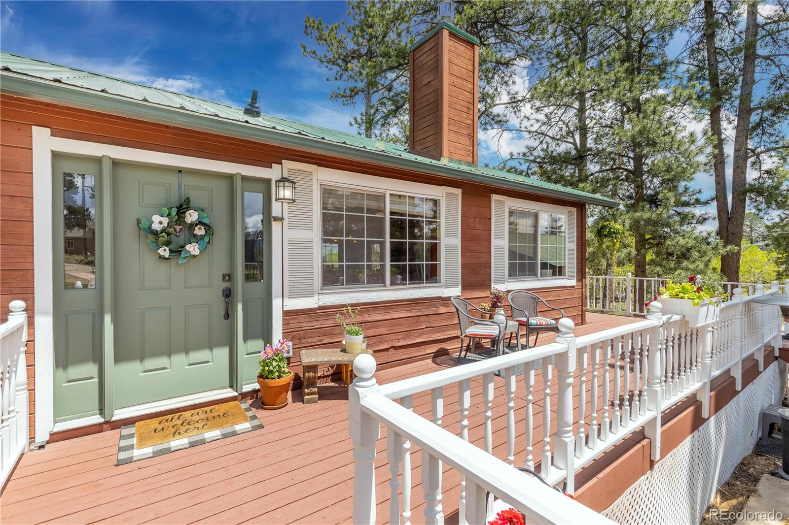 278 Overlook Drive Bailey, CO 80421 - Photo 22 of 37 a view of balcony with two chairs and wooden floor