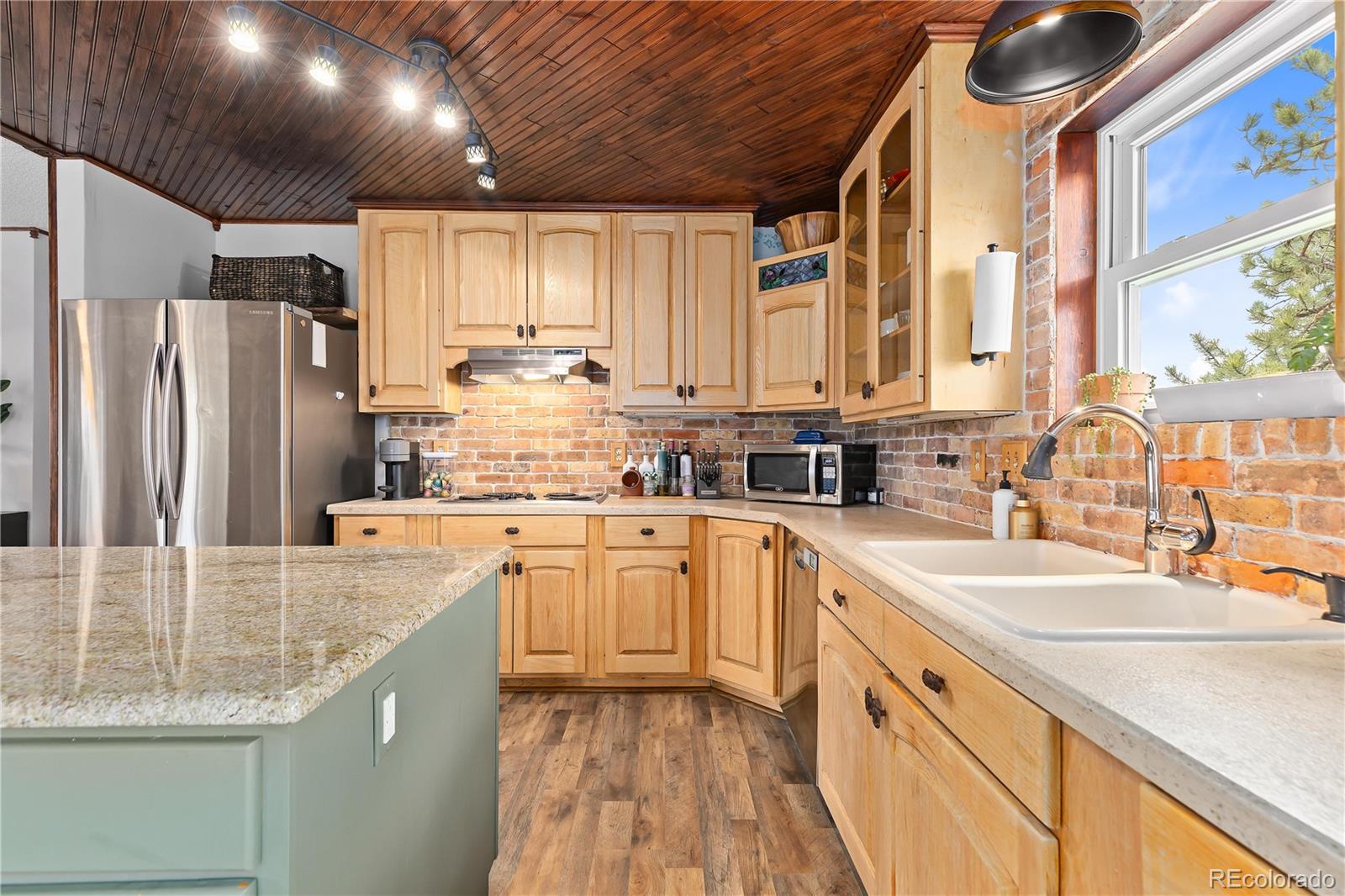 278 Overlook Drive Bailey, CO 80421 - Photo 10 of 37 a kitchen with stainless steel appliances granite countertop a sink stove and refrigerator