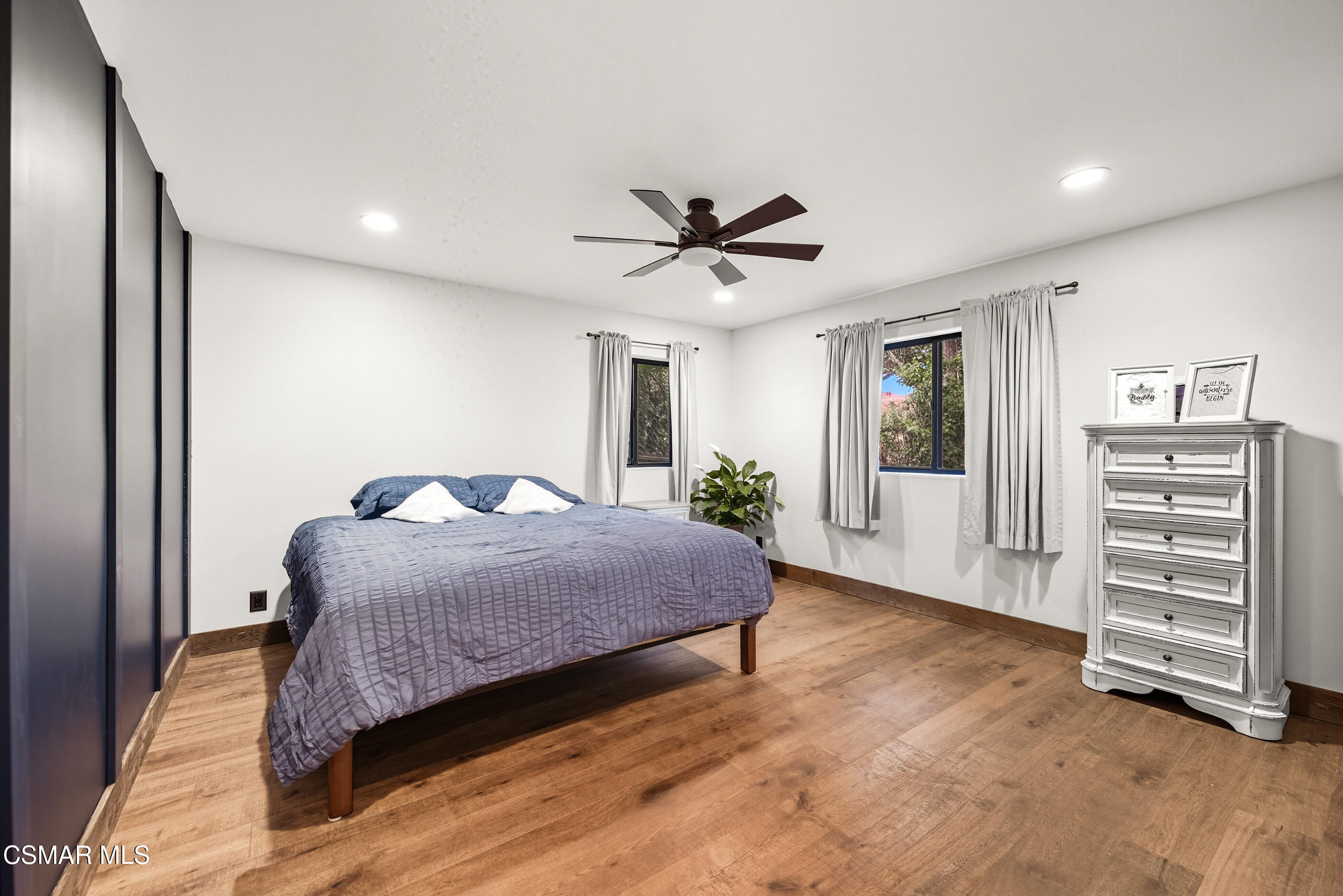 4351 Cornell Road Agoura Hills, CA 91301 - Photo 18 of 33 a bedroom with a bed a dresser and a chandelier