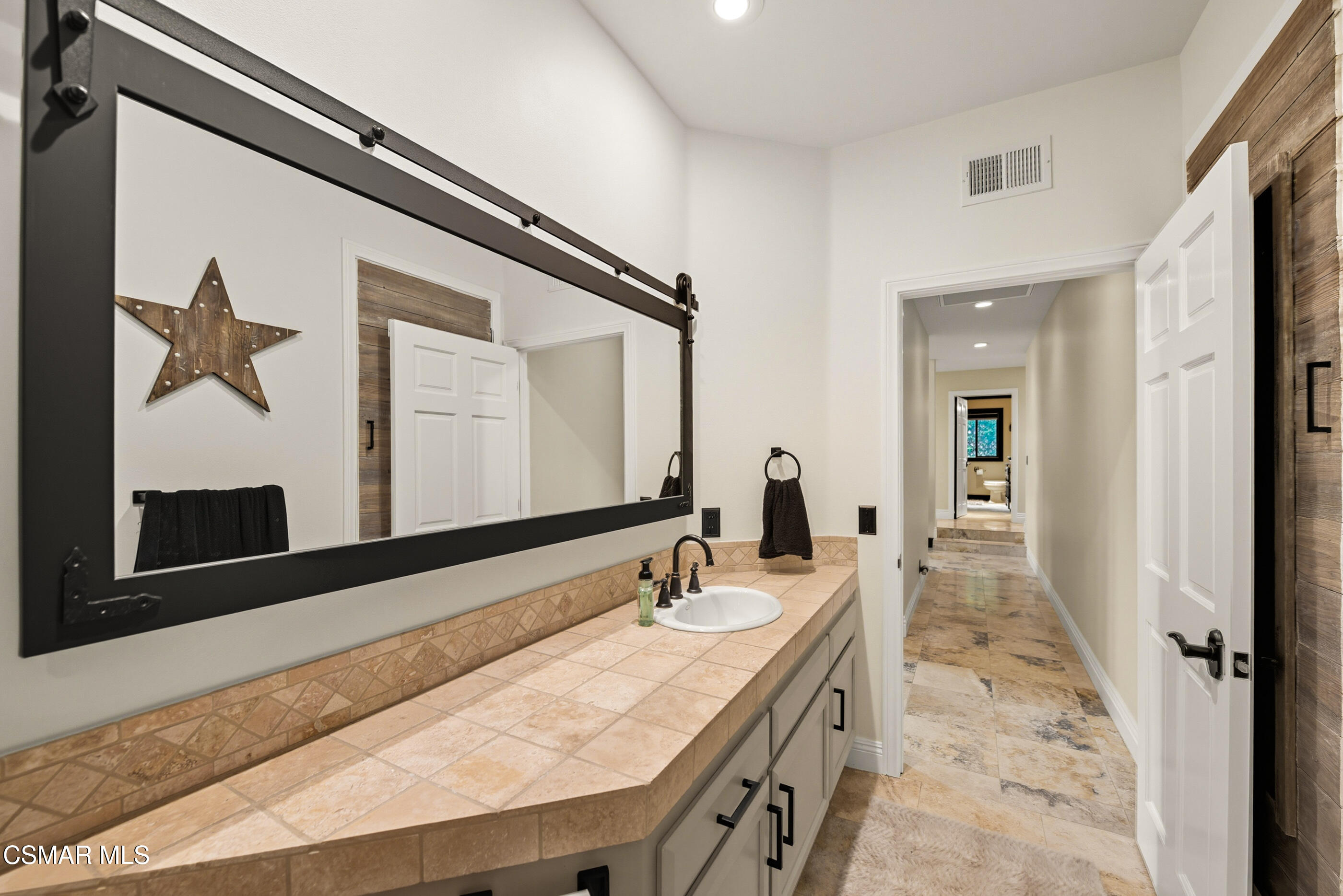 4351 Cornell Road Agoura Hills, CA 91301 - Photo 19 of 33 a bathroom with a sink a mirror and a shower