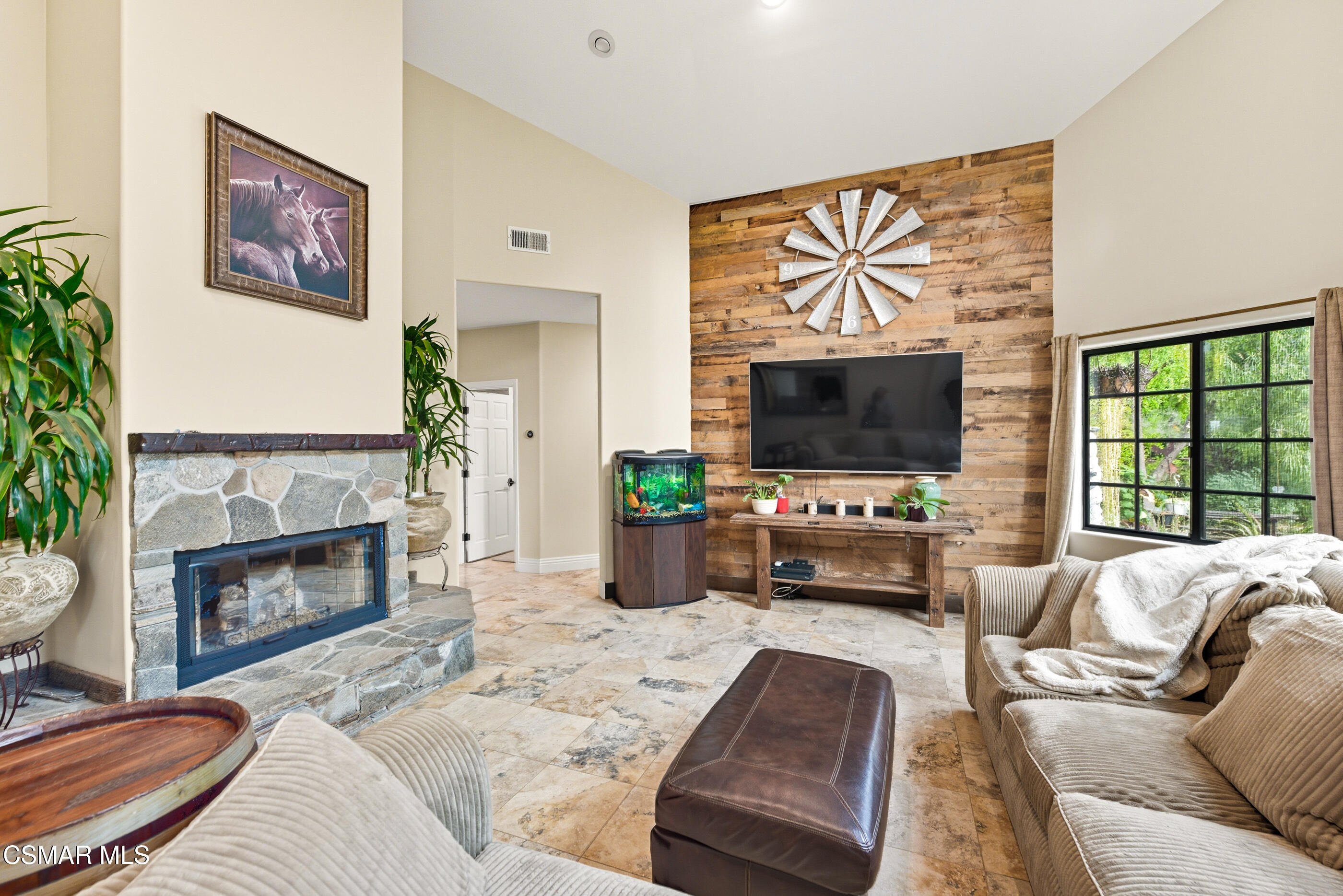 4351 Cornell Road Agoura Hills, CA 91301 - Photo 3 of 33 a living room with furniture a fireplace and a flat screen tv