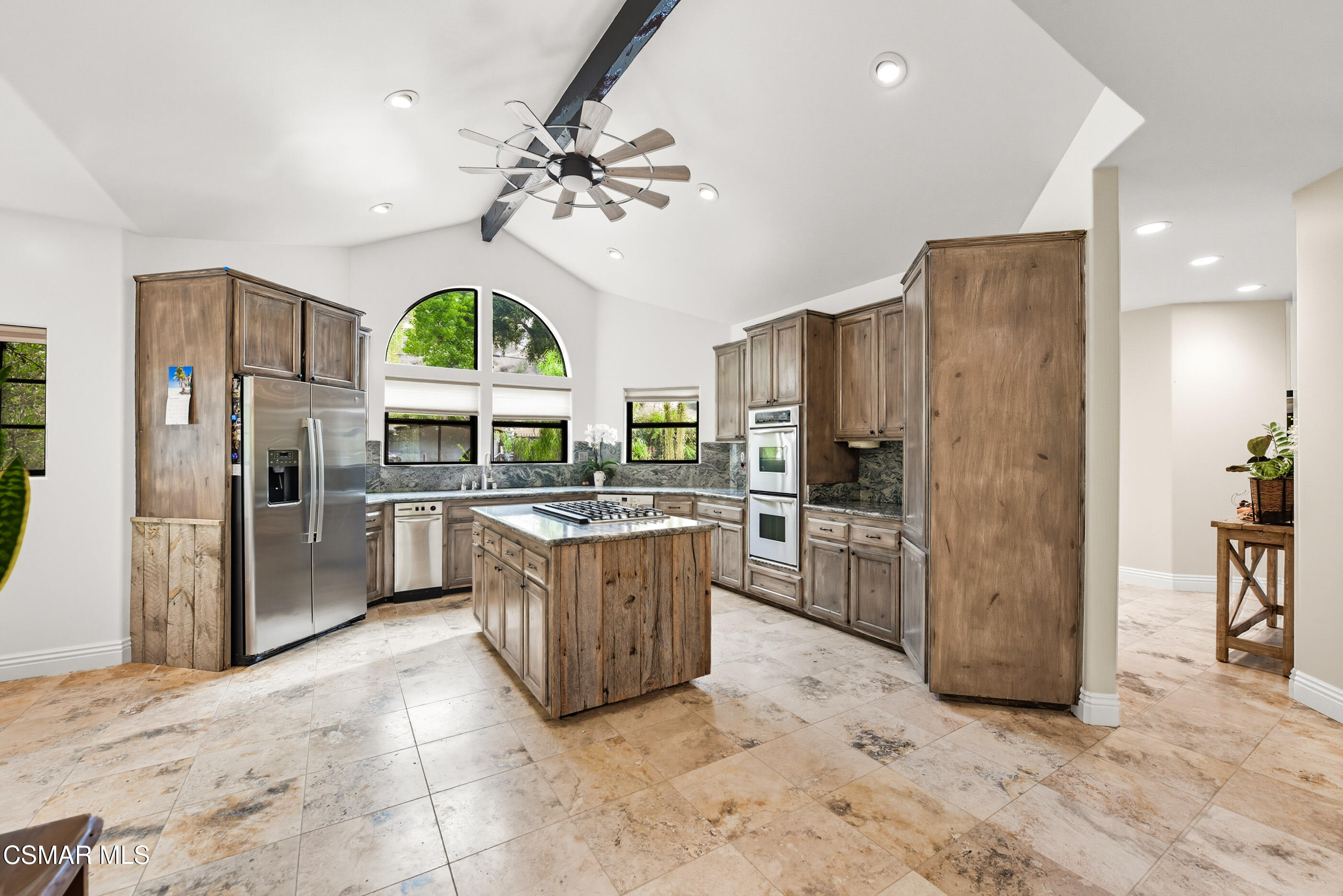 4351 Cornell Road Agoura Hills, CA 91301 - Photo 7 of 33 a kitchen with stainless steel appliances a refrigerator a stove a sink a oven and a dining table with wooden floor