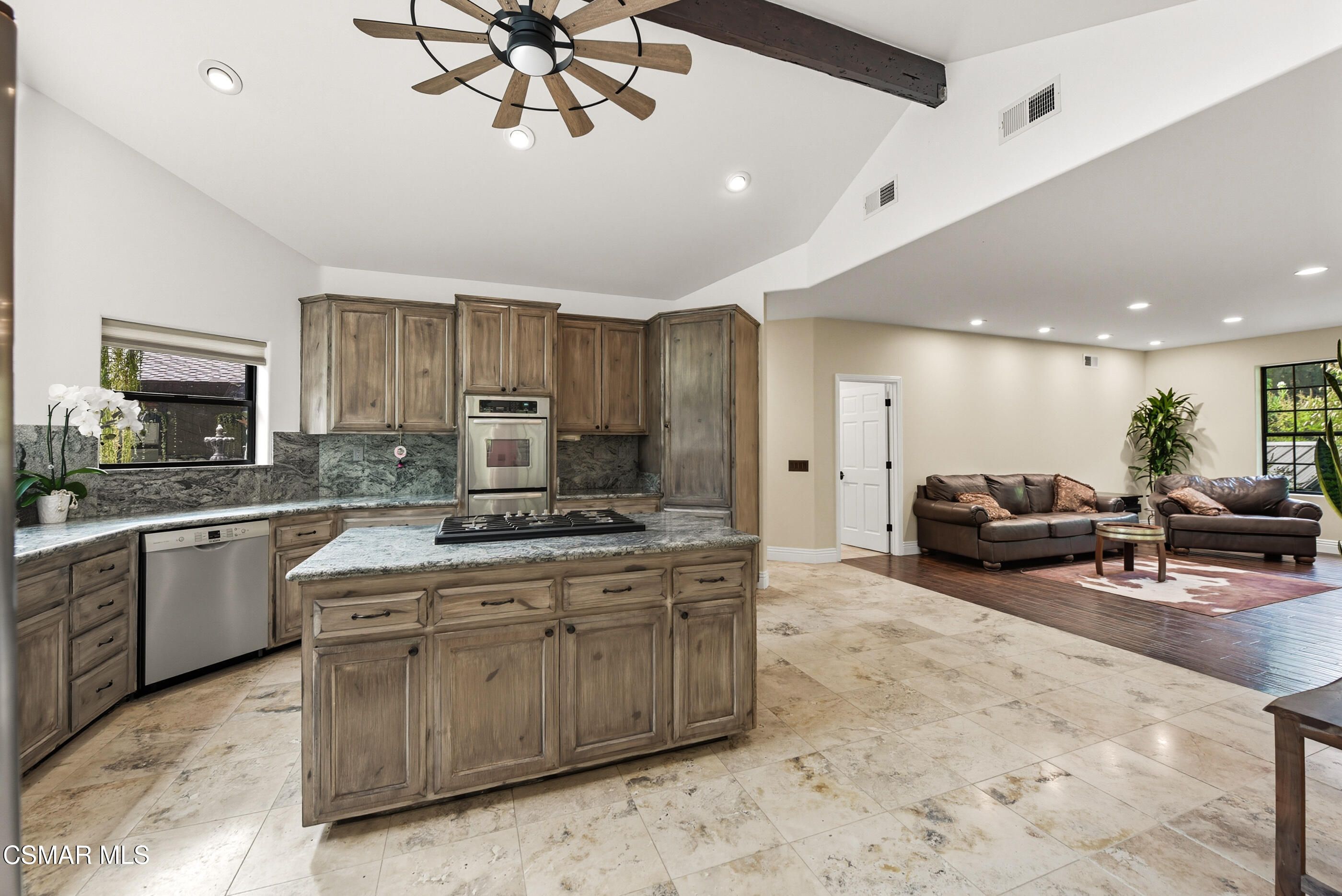 4351 Cornell Road Agoura Hills, CA 91301 - Photo 10 of 33 a kitchen with stainless steel appliances granite countertop a stove refrigerator a sink dishwasher with a dining table and chairs