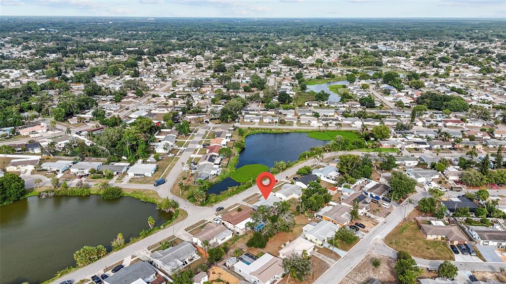 1623 Plum Tree Road Holiday, FL 34690 - Photo 25 of 33 an aerial view of residential building and lake