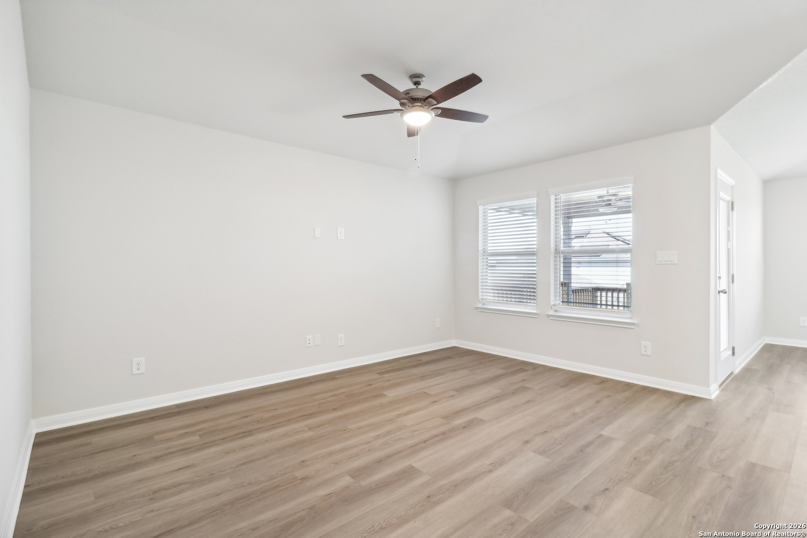 2907 Junction Bay Converse, TX 78109 - Photo 6 of 21 a view of an empty room with wooden floor and a window